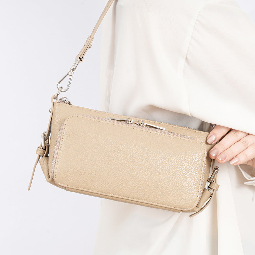 Light apricot leather bag held by model