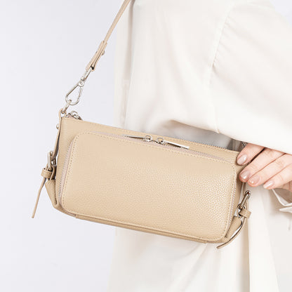 Light apricot leather bag held by model