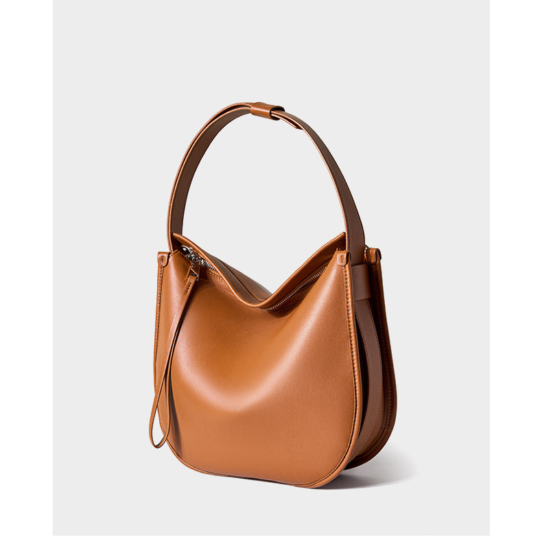 Tan leather hobo bag angled view showing zip closure and strap detail