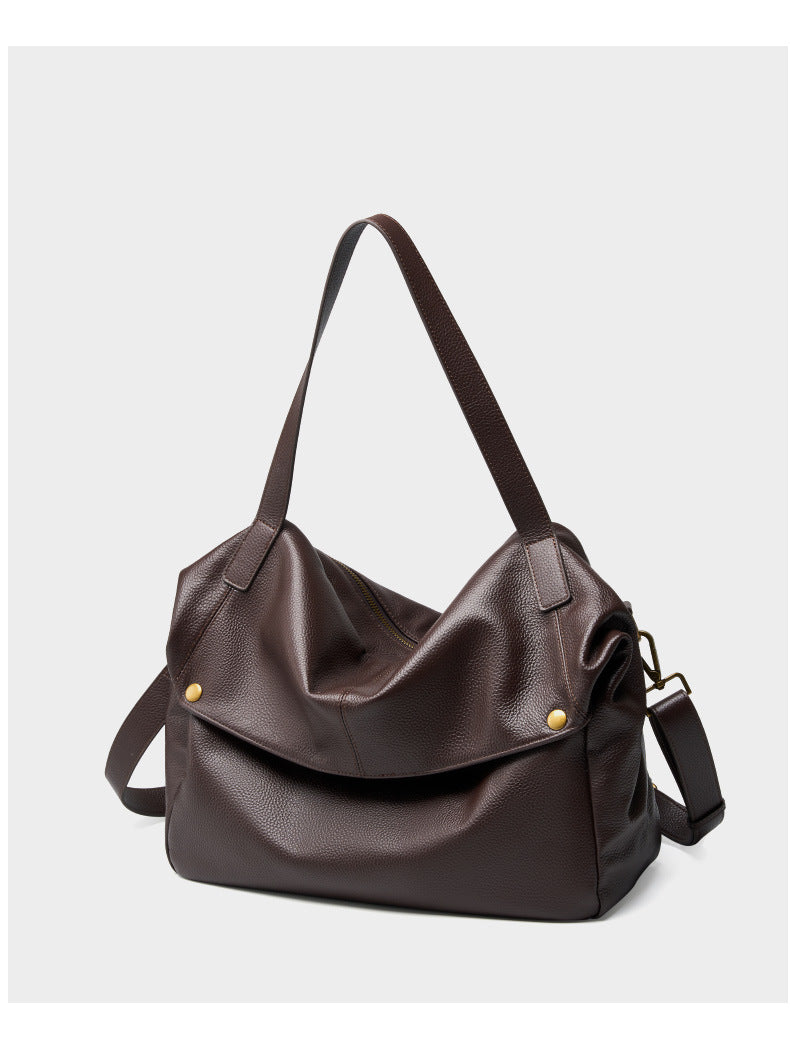 Front view of coffee brown pebbled leather tote with foldover flap and top handles