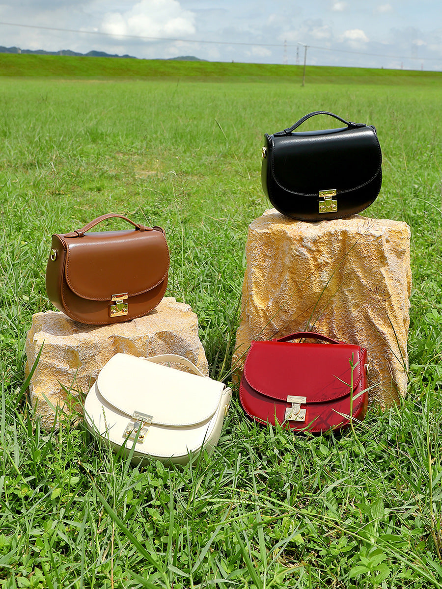 All four saddle bag colors displayed on stones in grass field