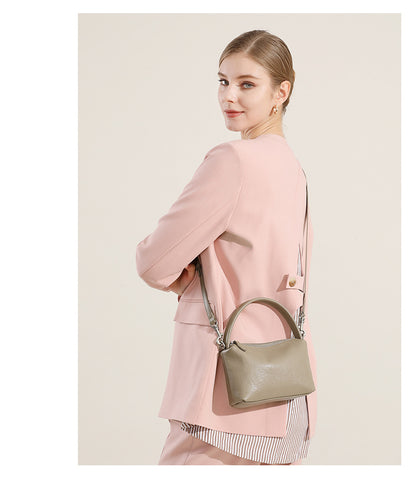 Side view of a model wearing the gray pillow bag crossbody