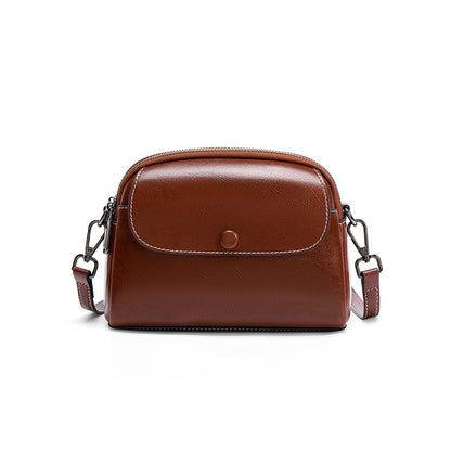 Coffee cowhide mini crossbody bag with snap flap on white background