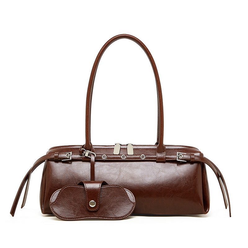 Front view of brown cowhide leather barrel tote bag with detachable sunglass pouch