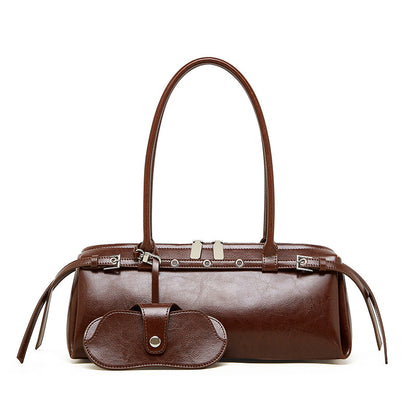 Front view of brown cowhide leather barrel tote bag with detachable sunglass pouch