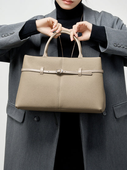 Model in gray blazer carrying elephant gray leather tote by top handles