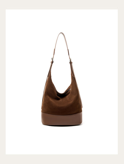 Front view of the coffee bucket shoulder bag on a light background