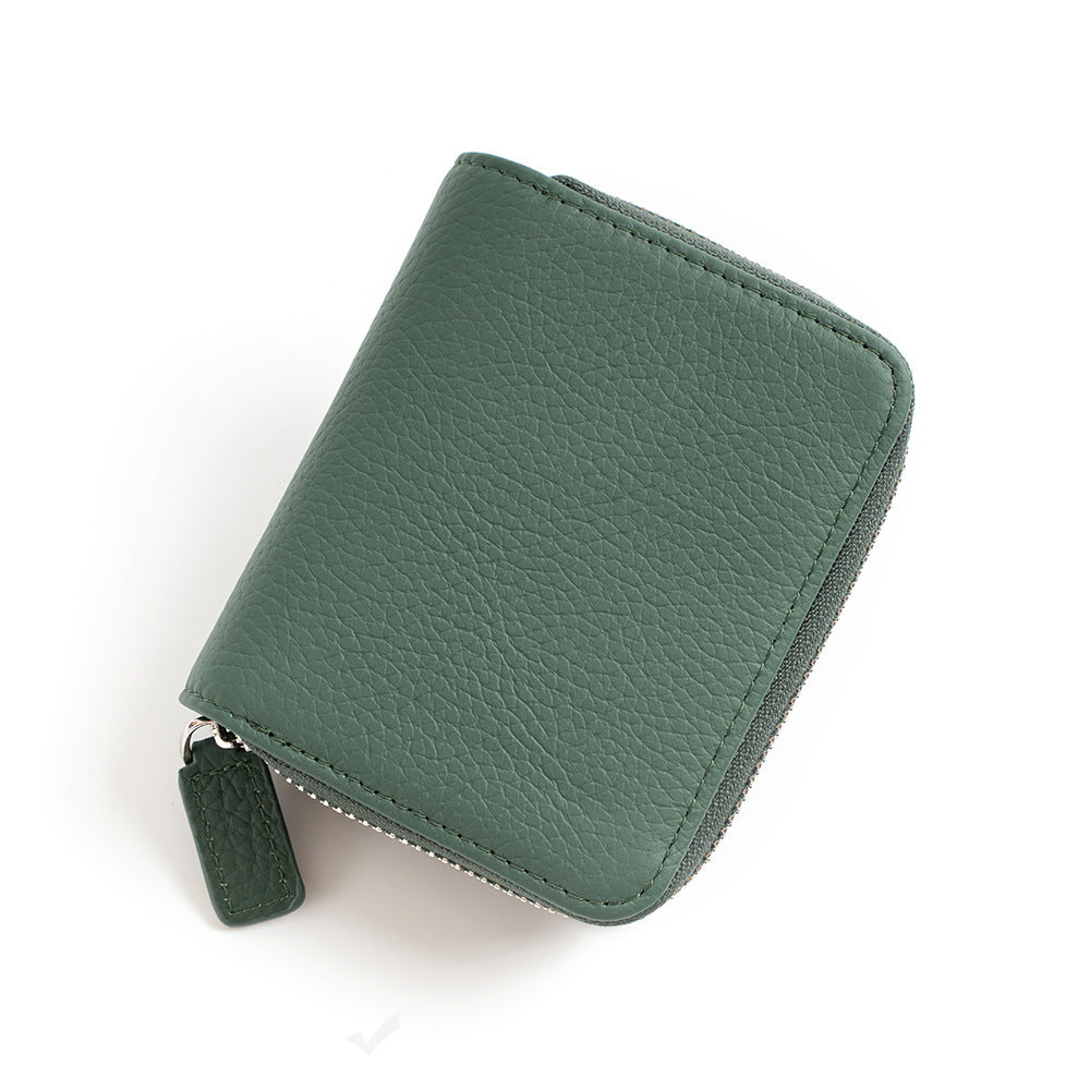 Jade green leather wallet with zip-around closure and leather pull tab