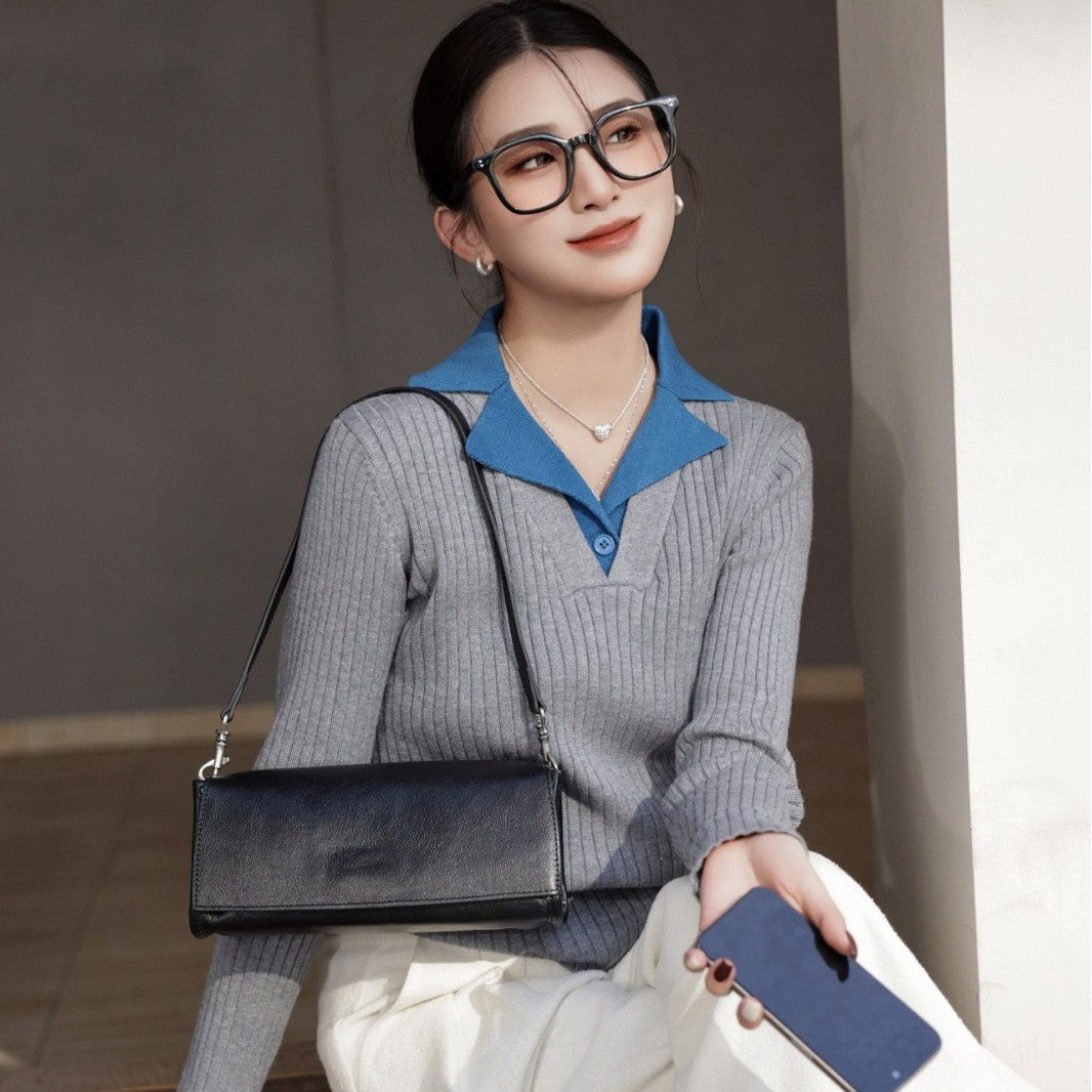 Black cowhide flap bag worn on the shoulder with a casual outfit