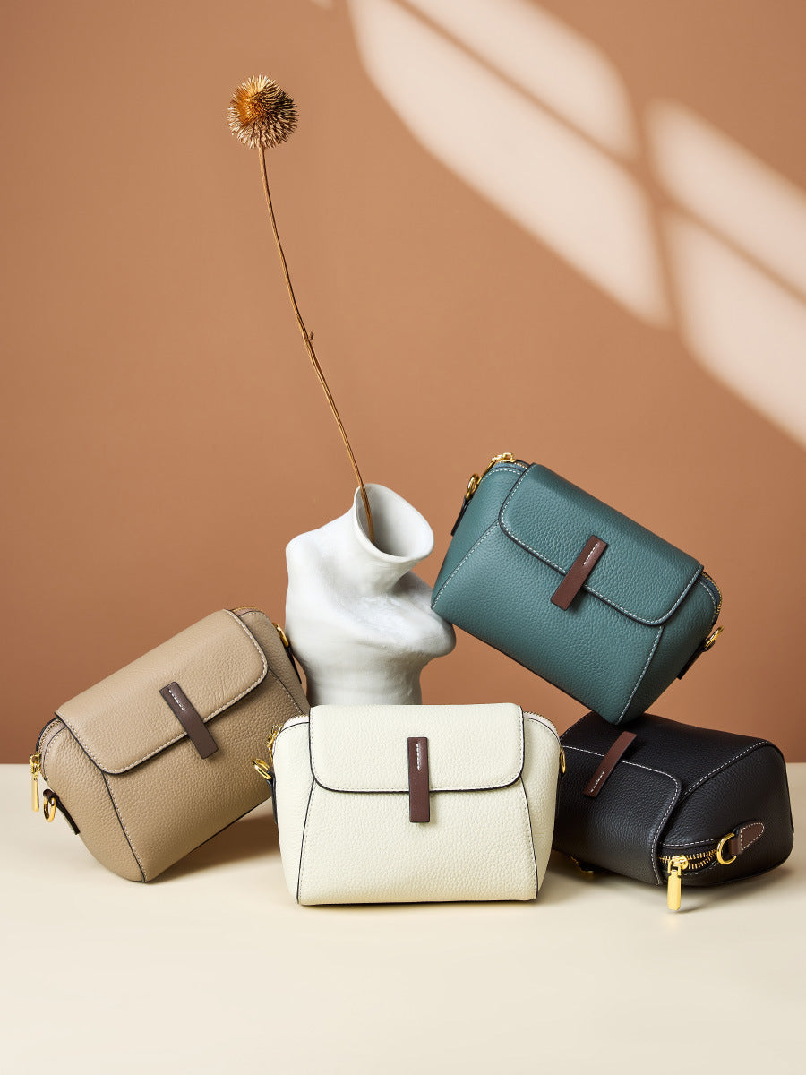 Four colorways of the shell crossbody bag arranged on a neutral studio set