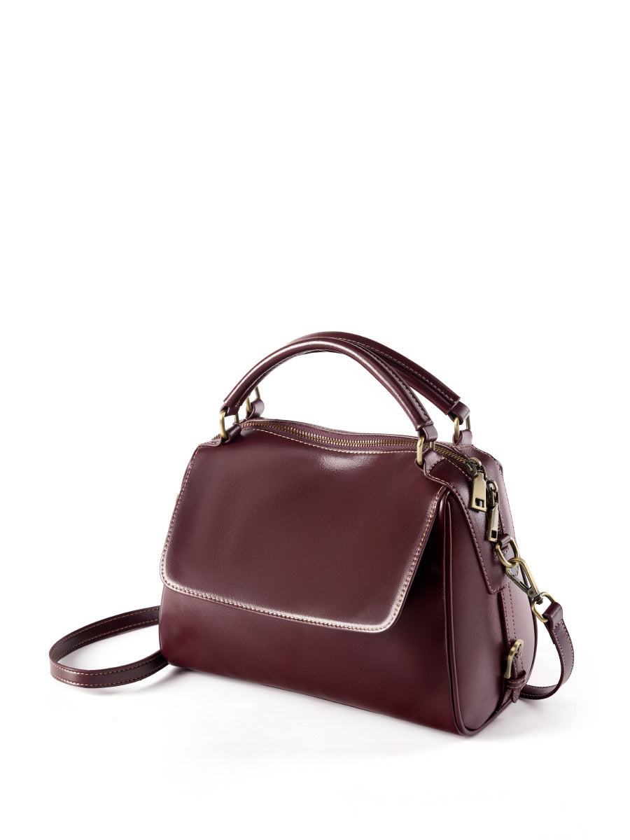 Wine brown Boston bag angled side view showing flap and zip closure