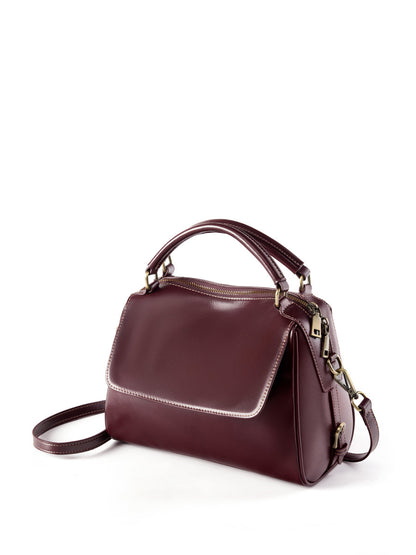 Wine brown Boston bag angled side view showing flap and zip closure