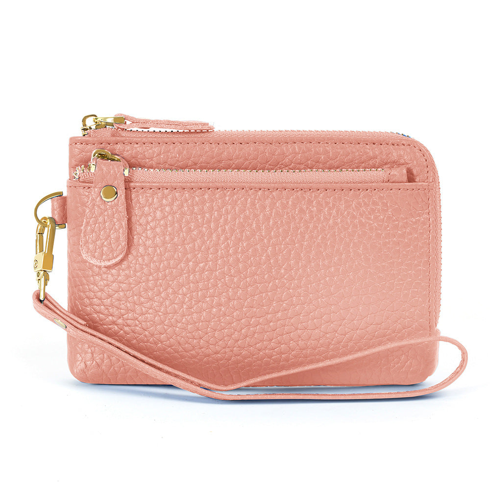 Pink leather compact zip wallet with coin pocket on back