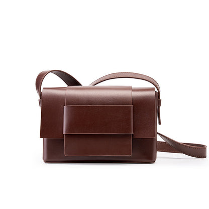 Coffee brown cowhide leather mini crossbody bag with bow front flap on white background