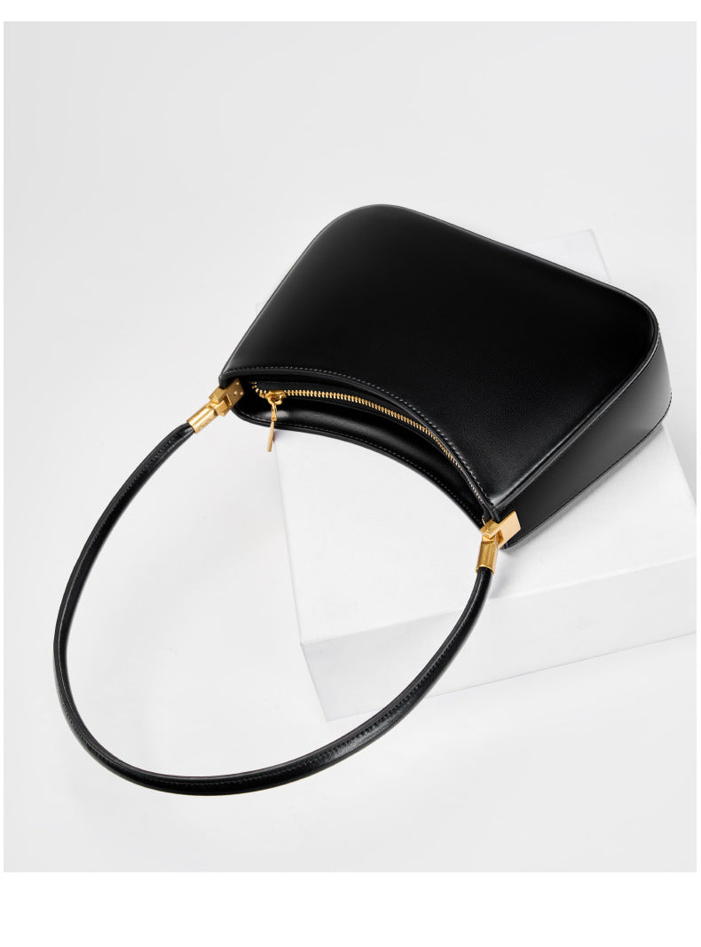 Black shoulder bag showing the top zip closure and strap hardware