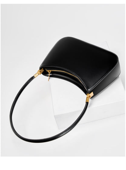 Black shoulder bag showing the top zip closure and strap hardware