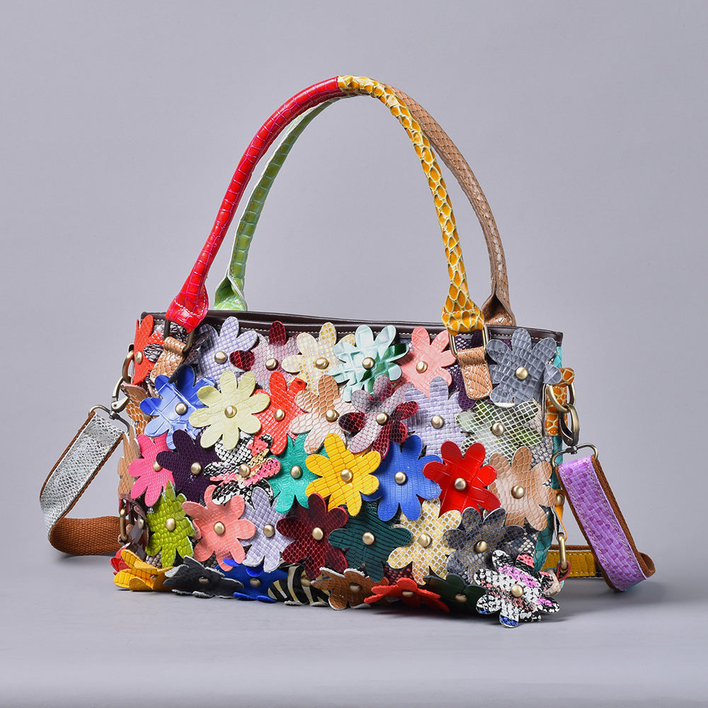 Front view highlighting the multicolor flower-covered bag silhouette