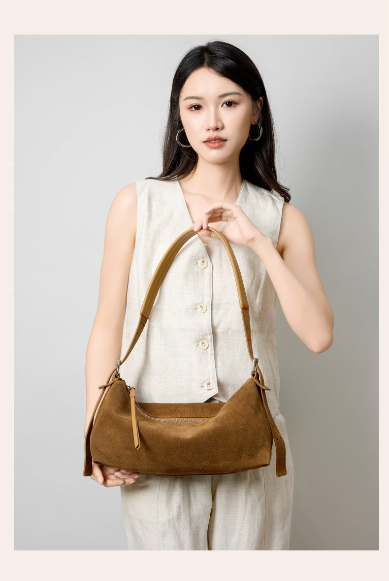 Two cowhide shoulder bags displayed with straps