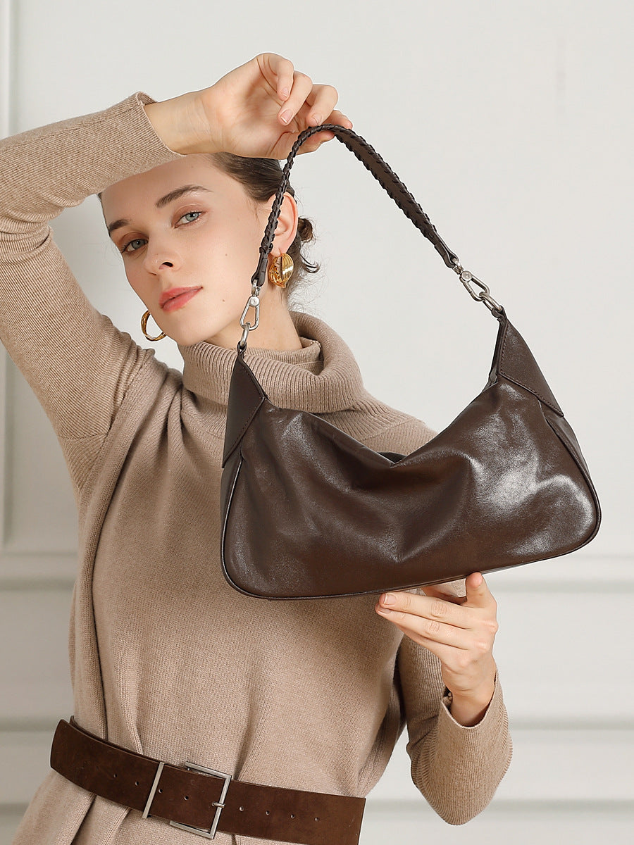 Dark brown hobo bag shown from the front while held by a model
