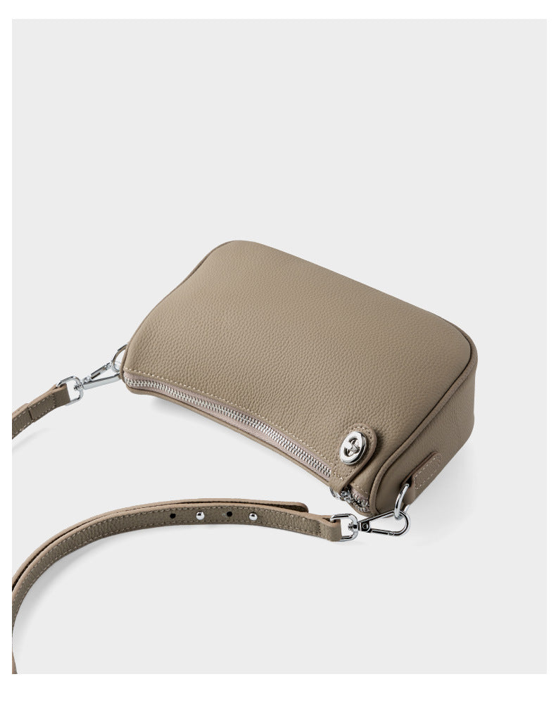 Back view of taupe bag showing zipper and strap connection