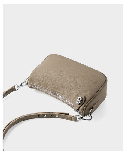 Back view of taupe bag showing zipper and strap connection