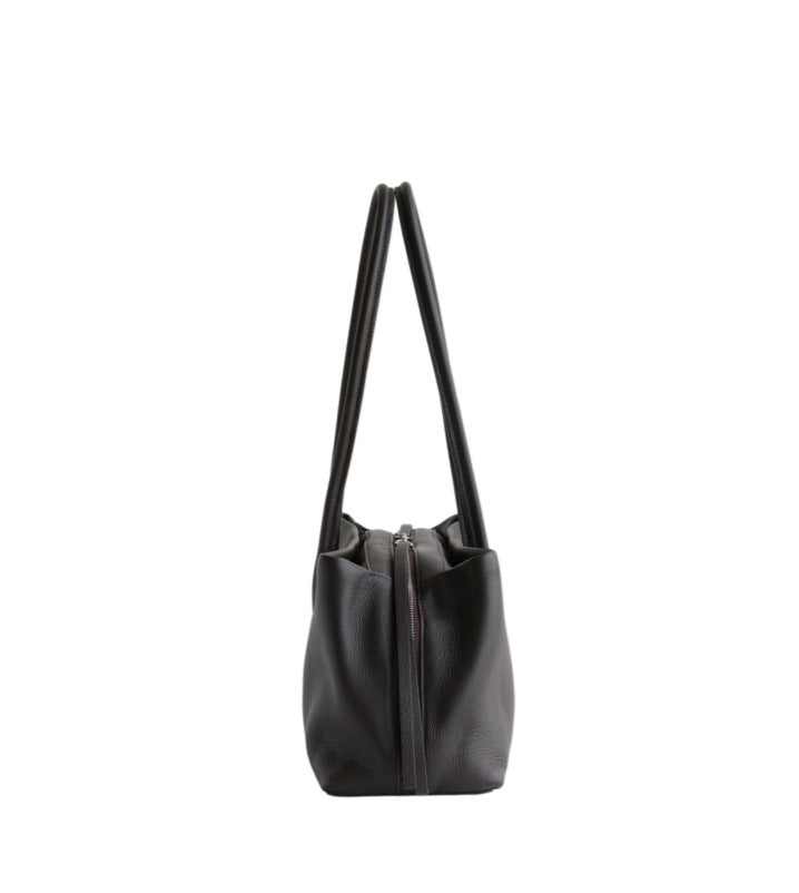 Black leather tote shown in profile