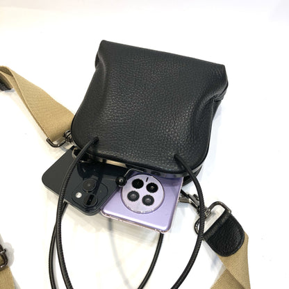 Open black frame bag with phone shown inside