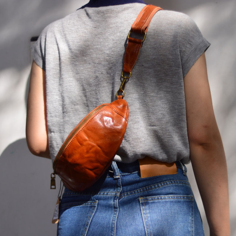 Close rear view of the brown leather sling bag and strap