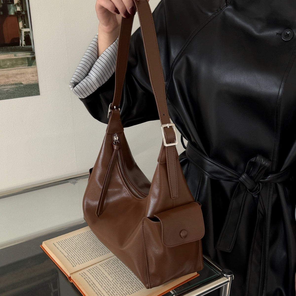 Model carrying the brown leather hobo shoulder bag