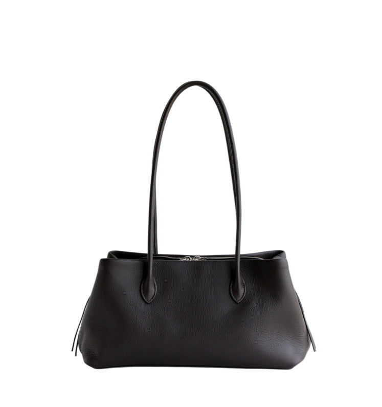 Black cowhide tote shown at a distance