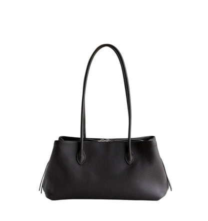 Black cowhide tote shown at a distance
