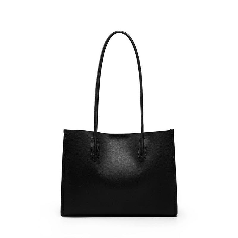 Black soft cowhide leather tote bag with long shoulder straps on white background