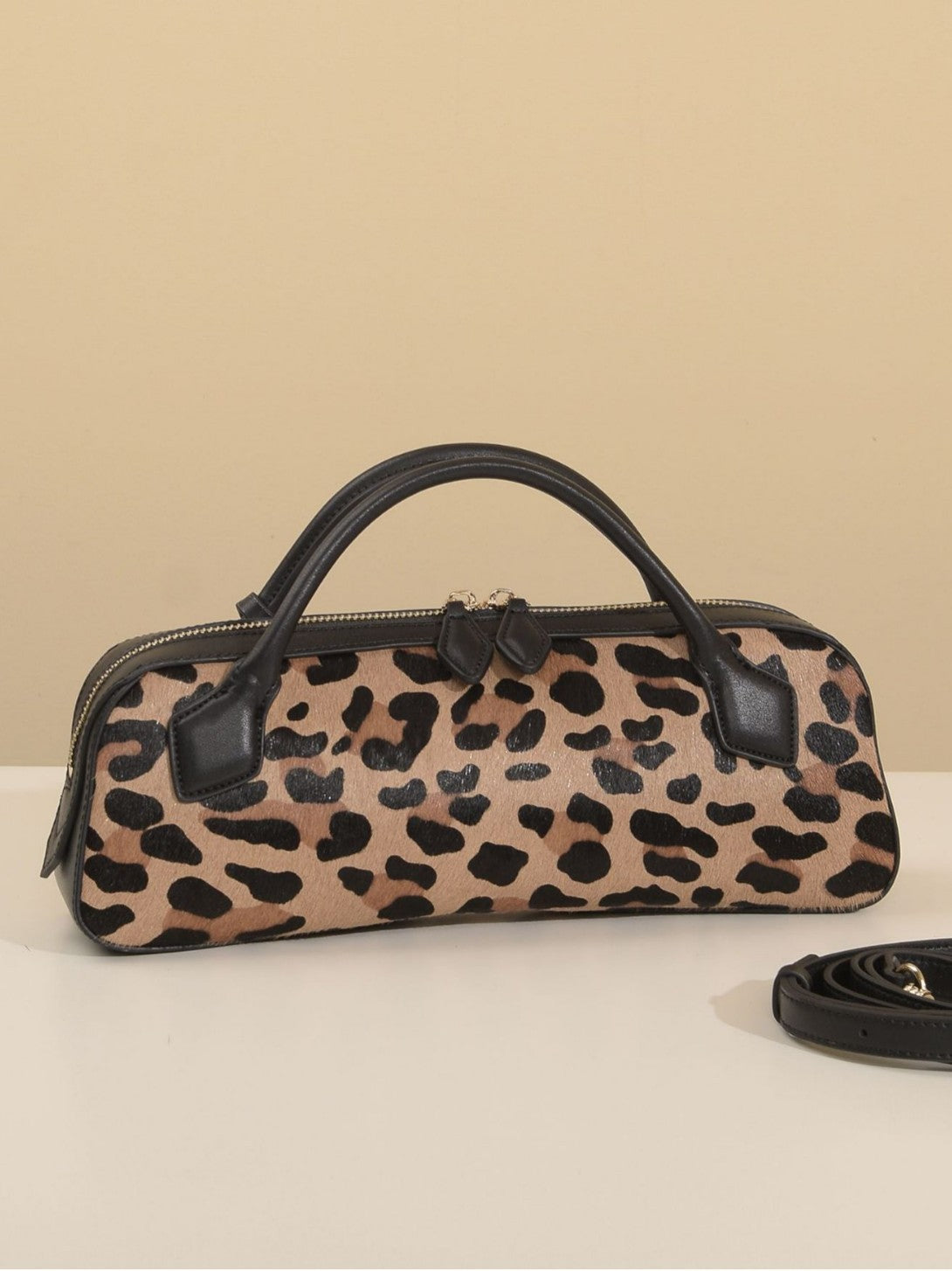 Front-facing leopard-print bag with detachable strap beside it