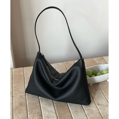 Black soft cowhide hobo bag displayed on a tiled surface