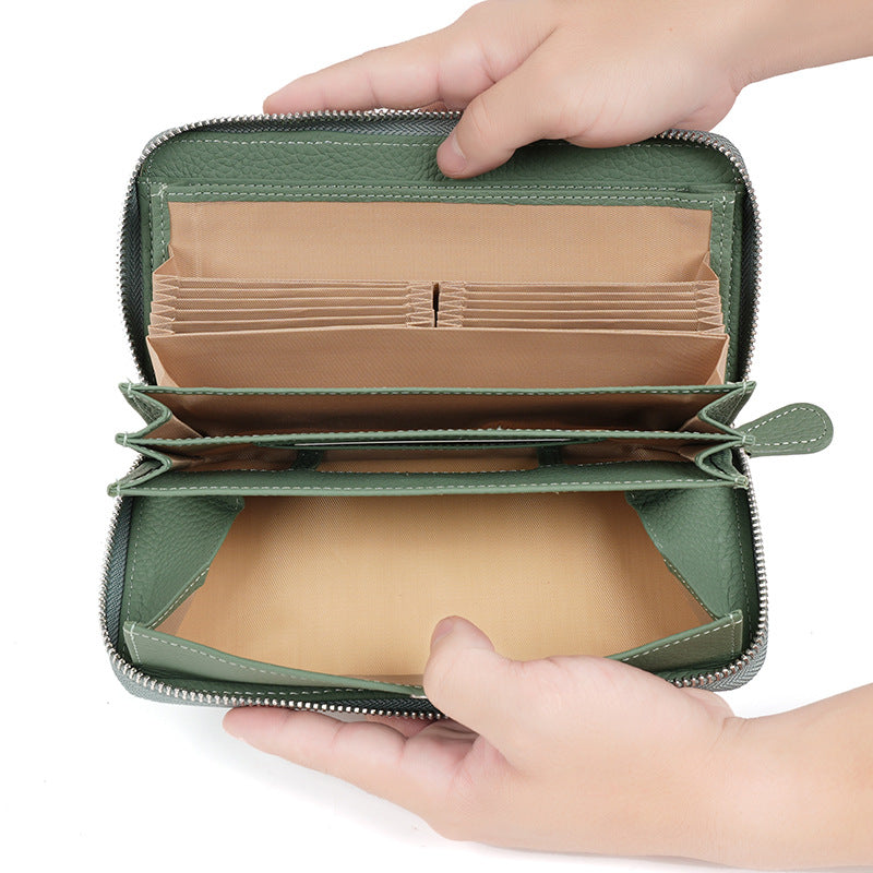 Open green wallet showing card slots and bill compartments