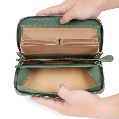 Open green wallet showing card slots and bill compartments