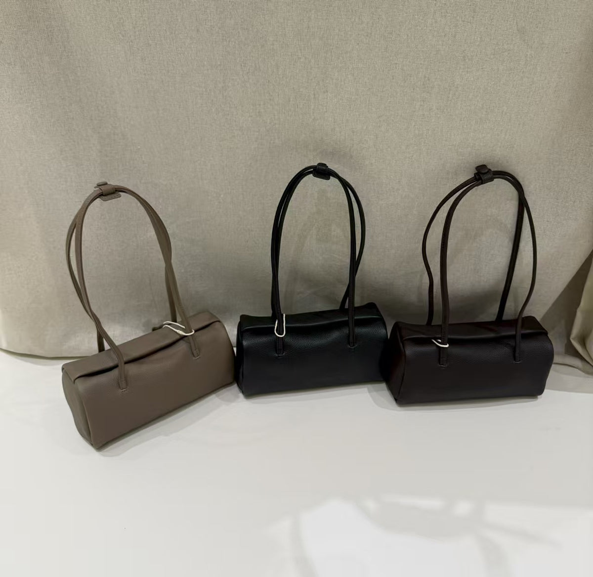 Close view of the bag straps and stitched attachment points