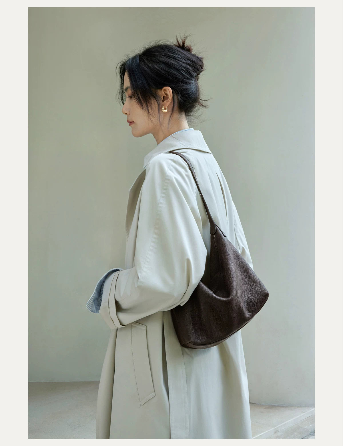 Dark brown hobo bag worn over the shoulder, close lifestyle view