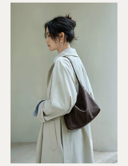 Dark brown hobo bag worn over the shoulder, close lifestyle view