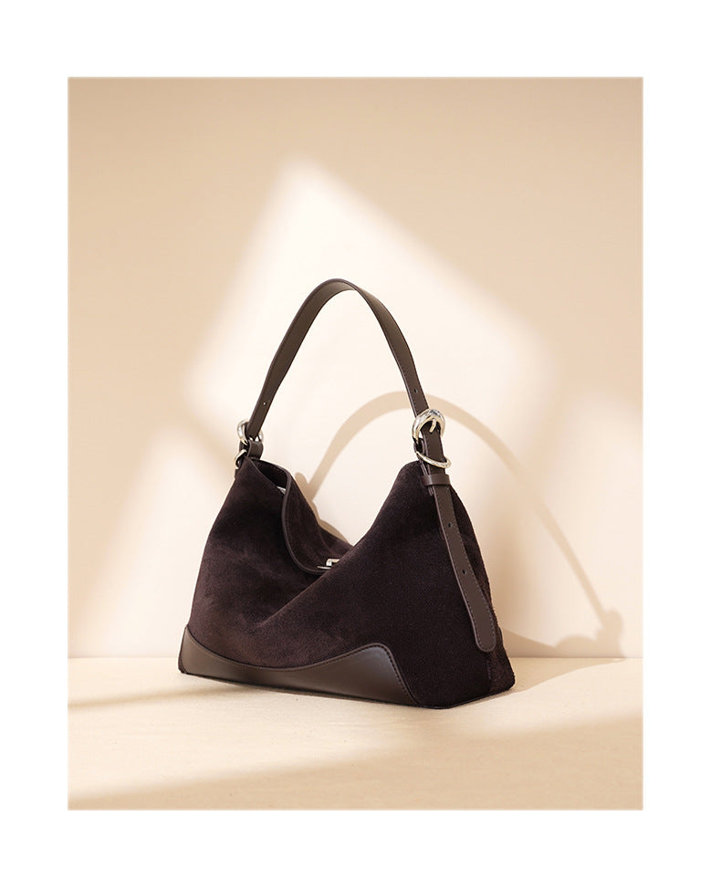 Brown tote with long strap arranged for crossbody carry
