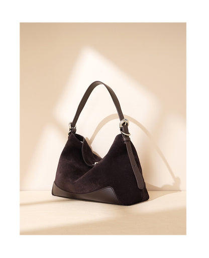 Brown tote with long strap arranged for crossbody carry