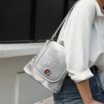 Silver gray split leather bucket bag worn on shoulder with white shirt