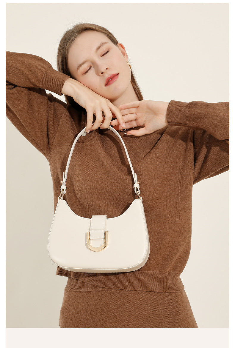 Model posing with cream white leather shoulder bag