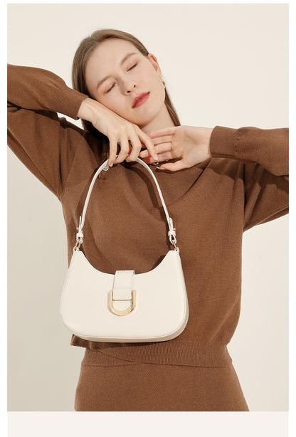 Model posing with cream white leather shoulder bag