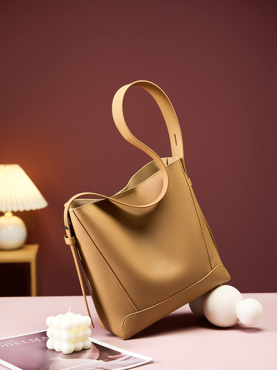 Golden Brown bucket bag on table with lamp