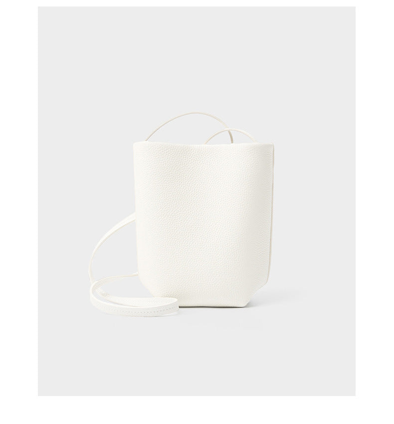 Off-white top-grain cowhide mini bucket bag with thin shoulder strap