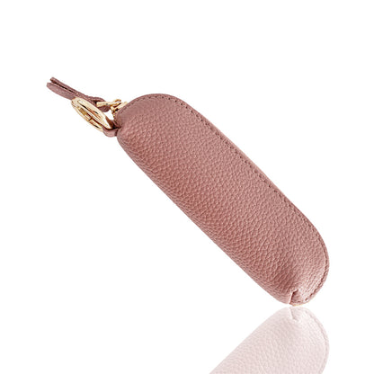 Pink top-grain cowhide mini zip coin purse with gold-tone swivel key clip on white background