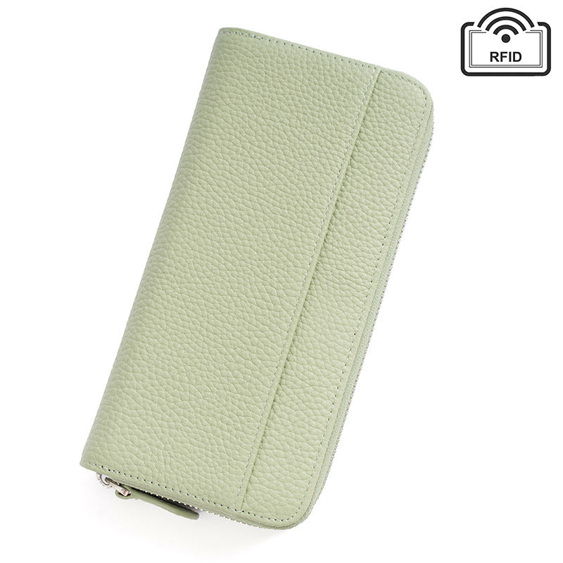 Closed pale green textured leather wallet with RFID blocking icon