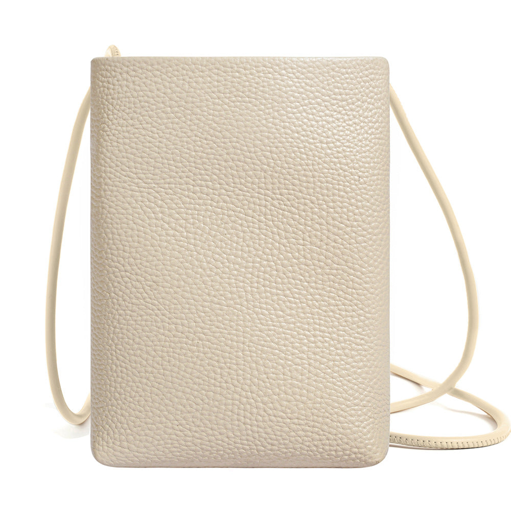 Offwhite pebbled leather phone bag with adjustable strap front display