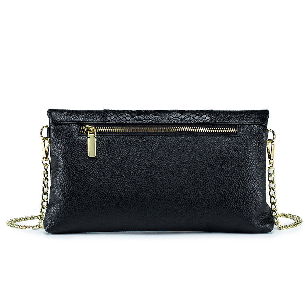 Back view of black cowhide clutch showing exterior zip pocket